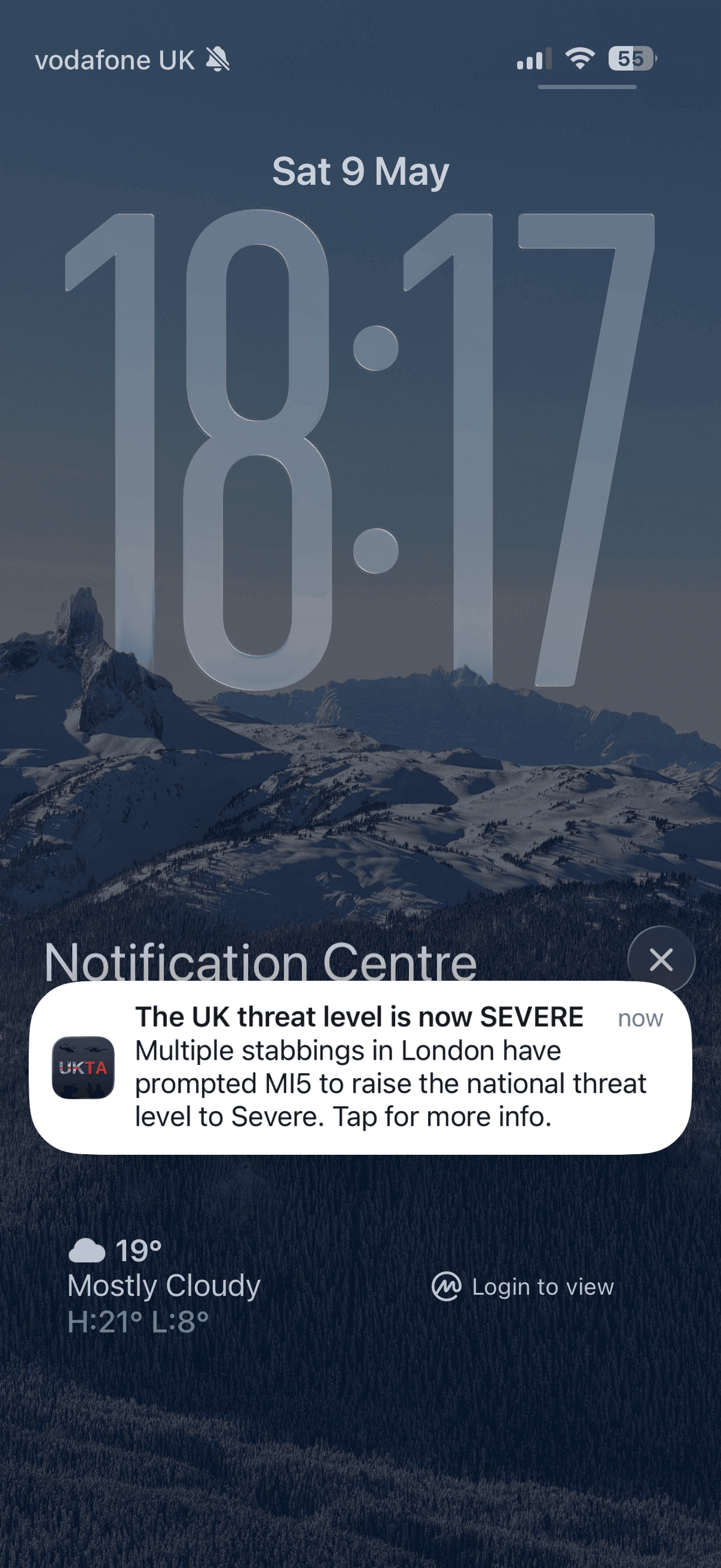 iPhone lock screen showing a UK Terror Alert push notification raising the threat level to Severe